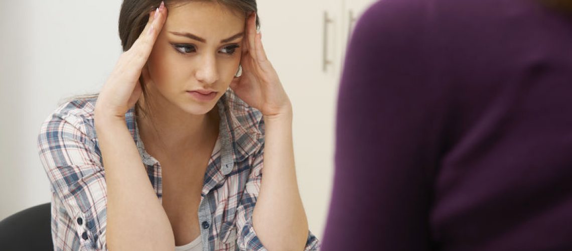 49045263 - teenage girl visiting counsellor to treat depression
